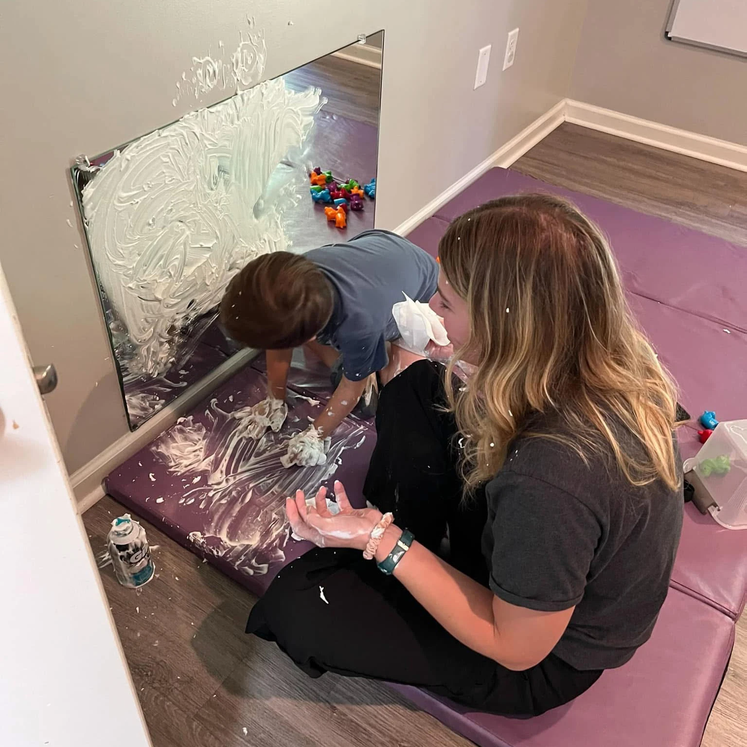 pediatric therapist supporting a child during therapy at Alabama Pediatric Therapy Services